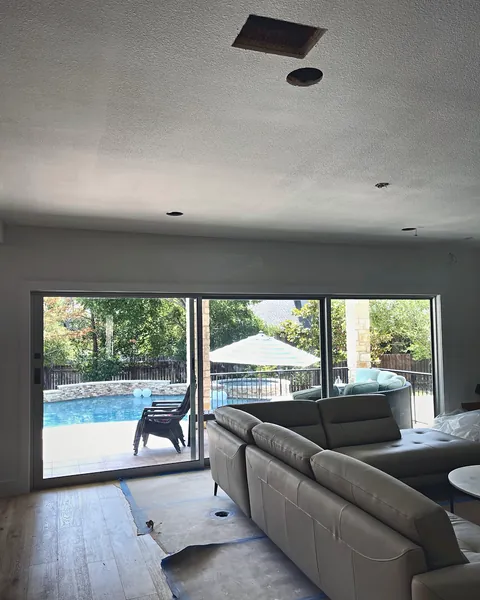 New sliding glass patio door opening to a backyard pool