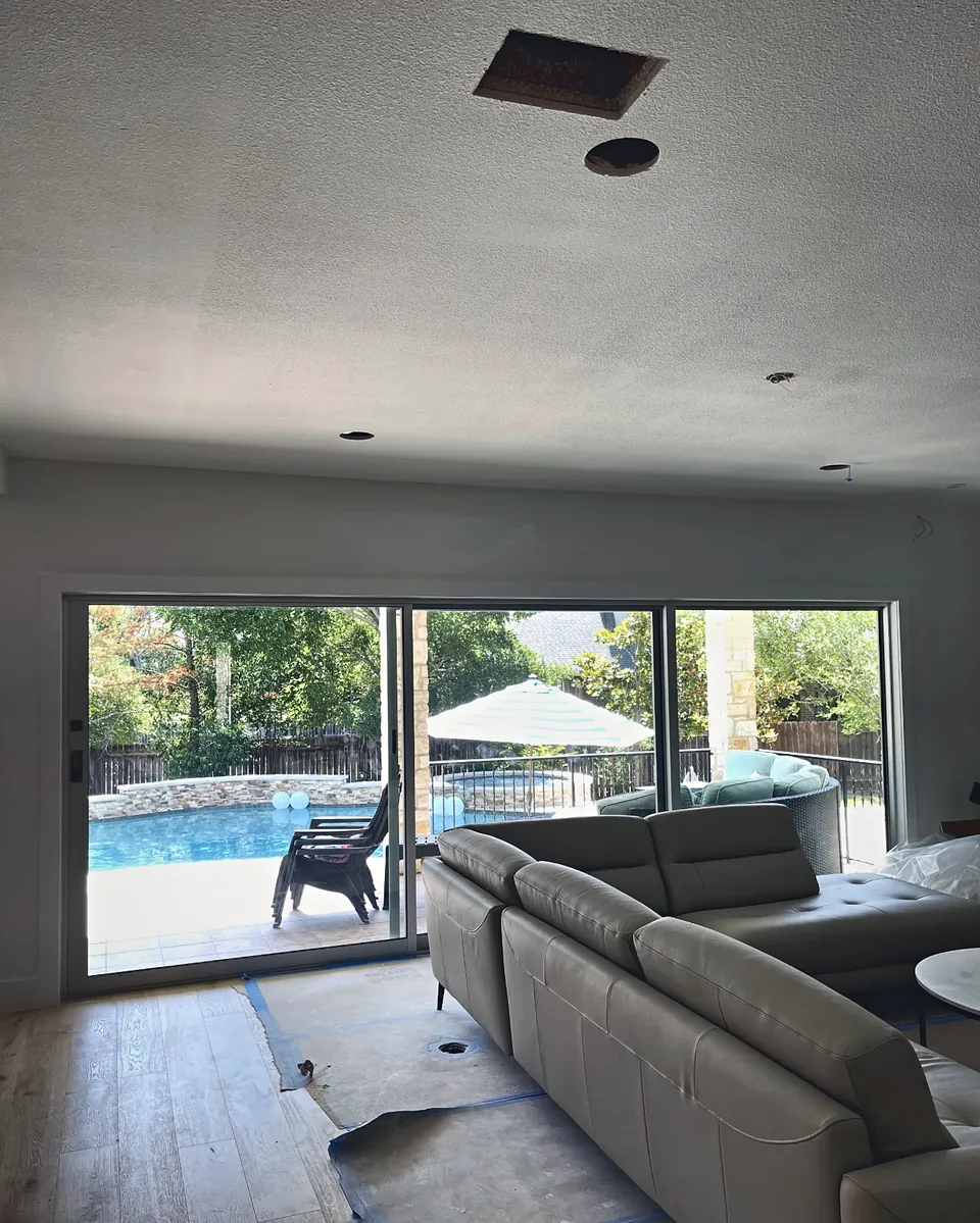 New sliding glass patio door opening to a backyard pool